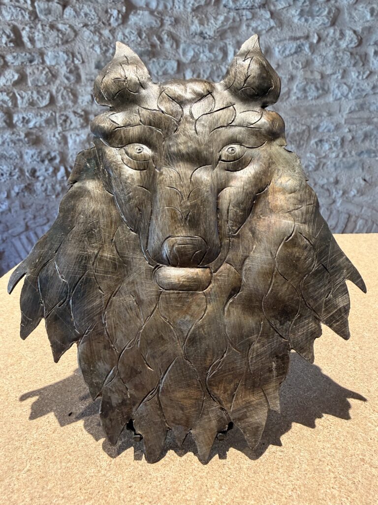 Hand-carved metal wolf sculpture in Gubbio, inspiring bespoke hardware and custom accents for luxury interior design in London, Milan, and Miami