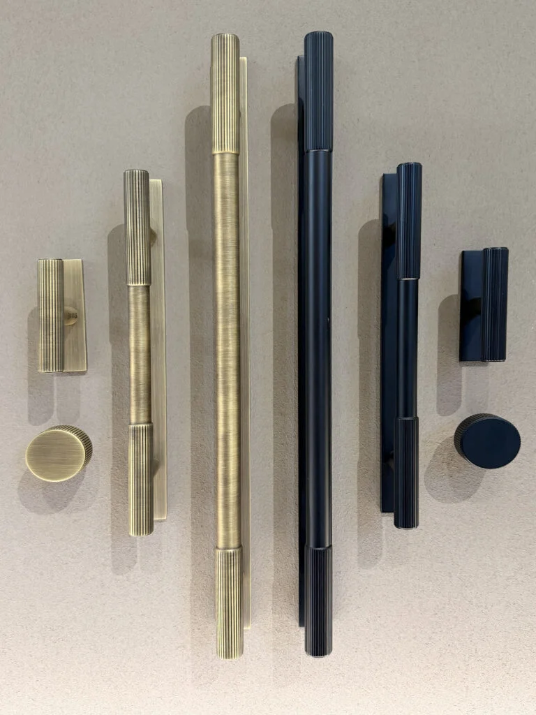 Fluted reeded brass and matte black architectural cabinet pull handles and knobs at Decorex London