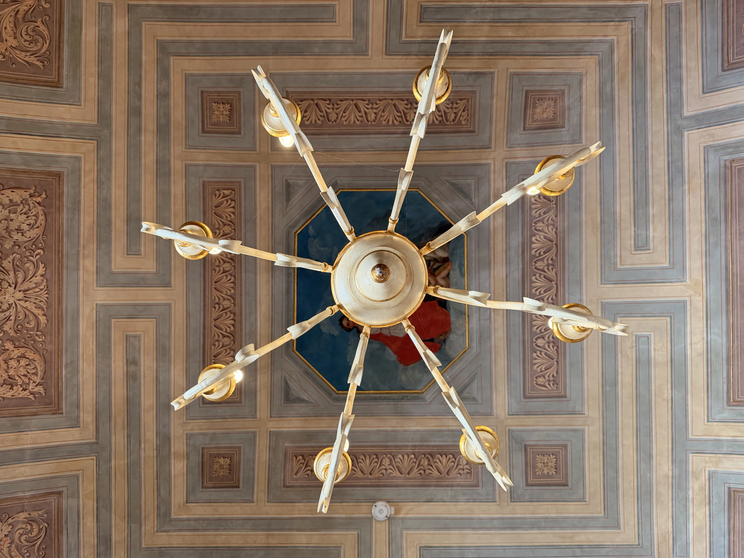 Classical ceiling fresco and chandelier details at Muma in Gubbio, inspiring luxury interior design in London and Milan