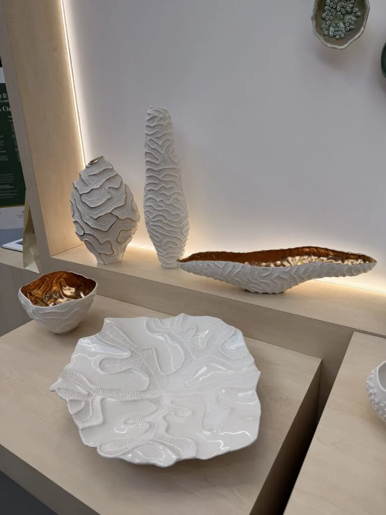 Sculptural white porcelain vessels with organic coral textures and gold leaf interior at Decorex London